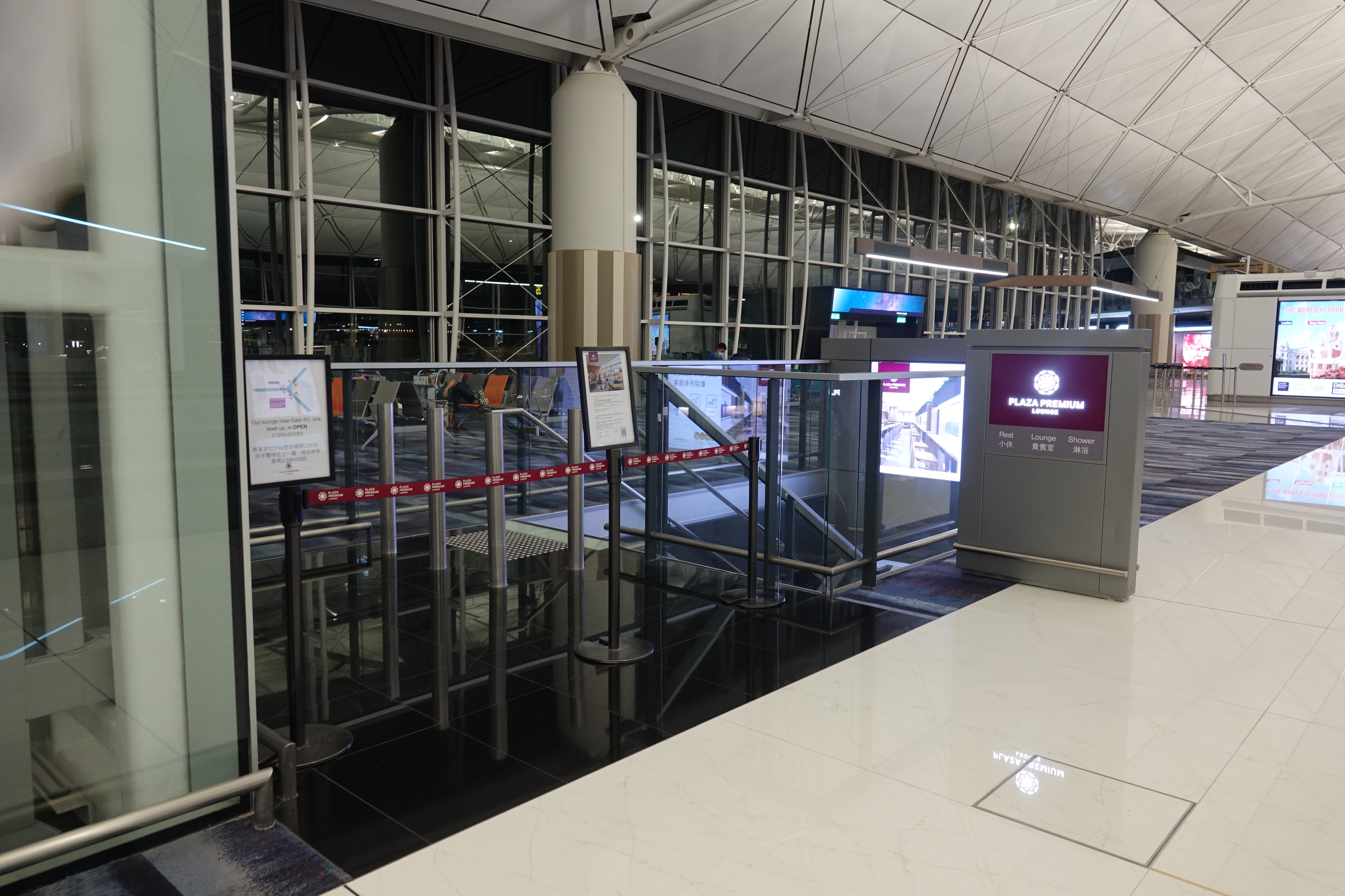 a building with a glass wall and a metal gate