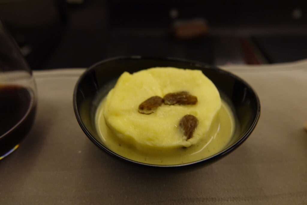 a bowl of food with a brown object in it