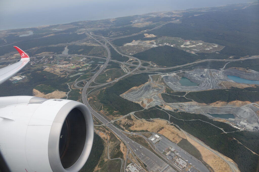 an airplane wing and a landscape