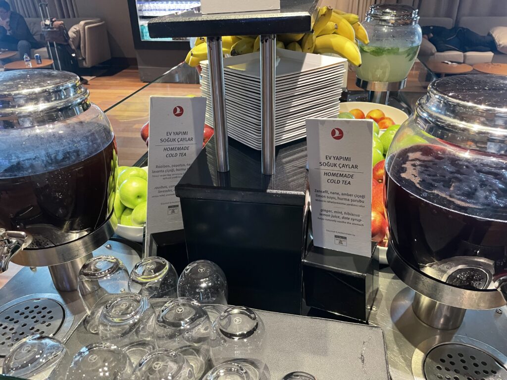 a table with a variety of drinks and fruits