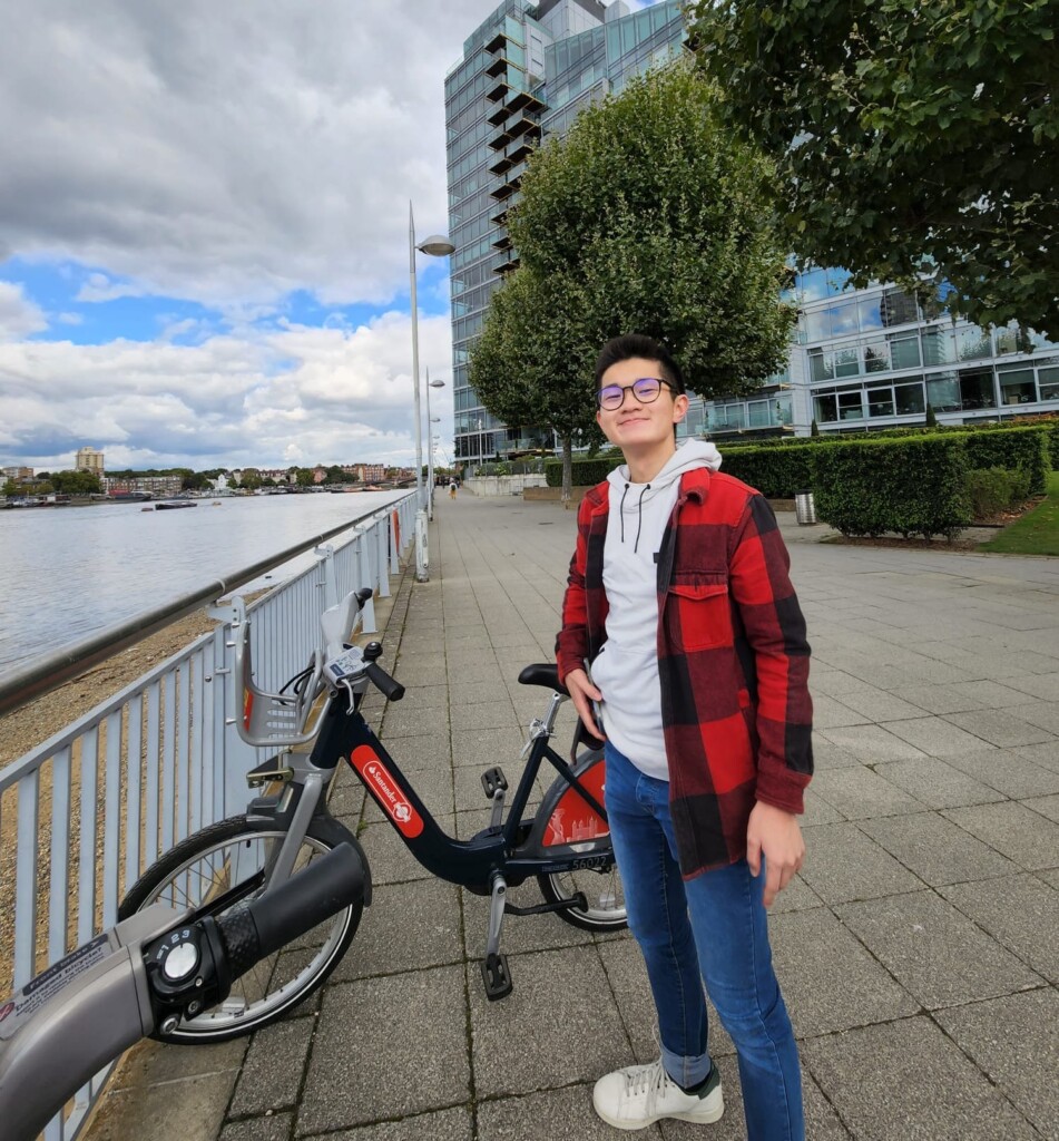 a man standing next to a bicycle