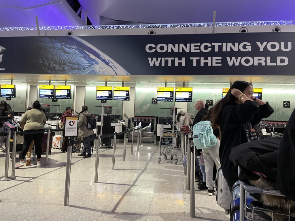 people standing in a line at an airport