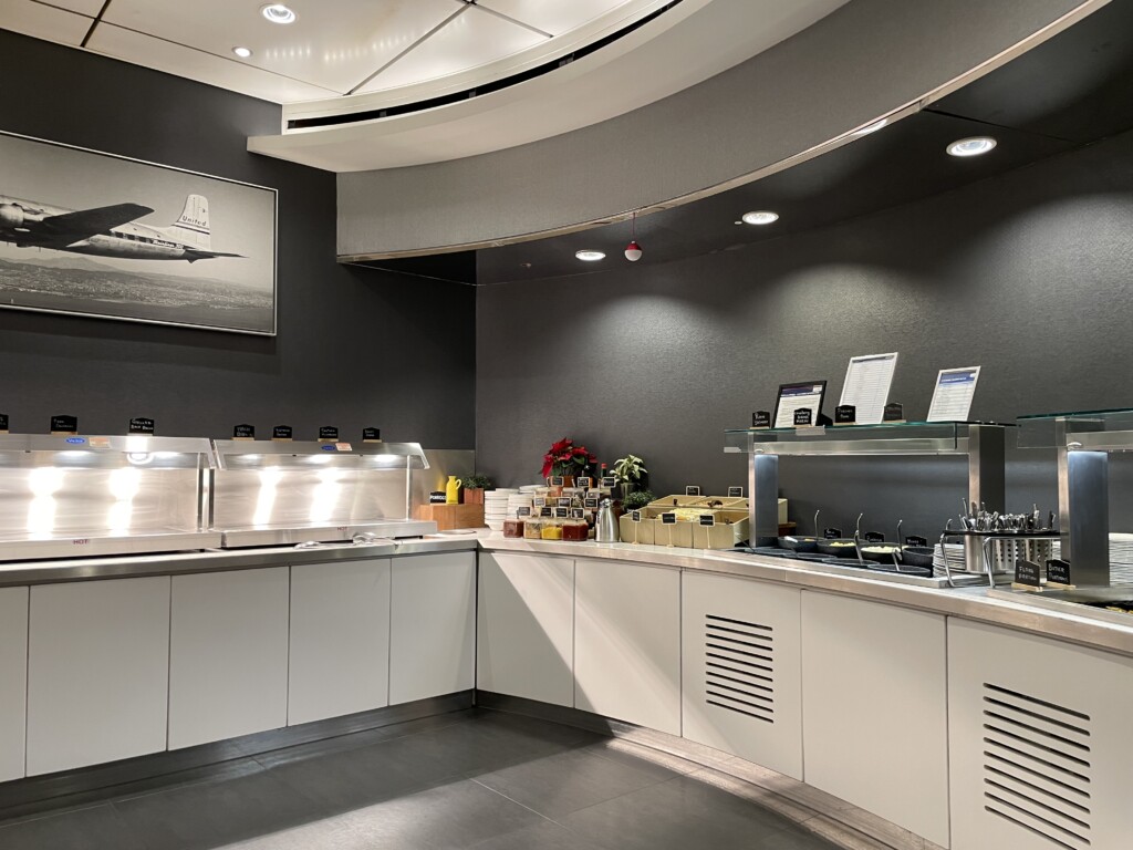 a kitchen with white cabinets and a picture of an airplane