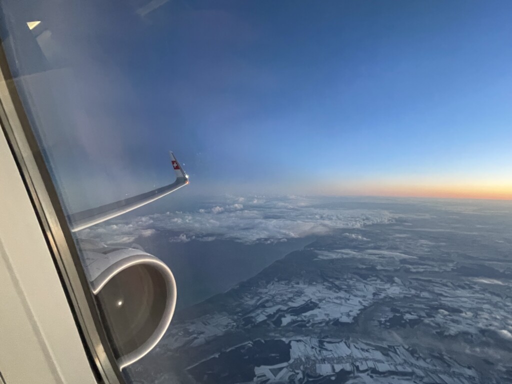 an airplane wing and a view of the sky