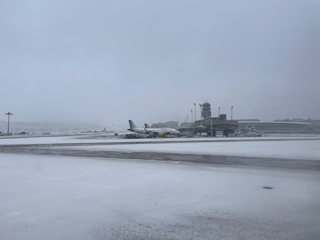 an airplane on a runway in the snow