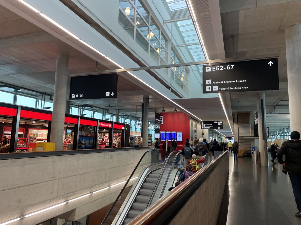 people walking on an escalator in a building