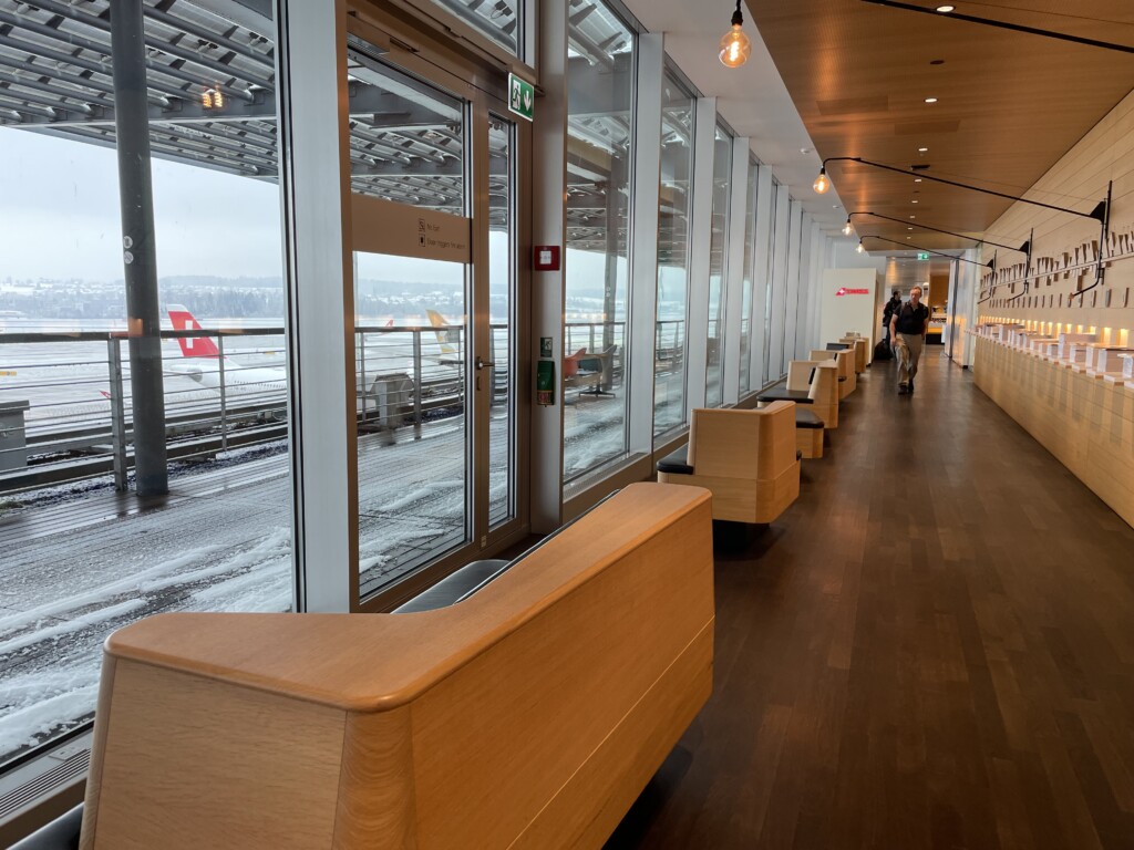 a long hallway with benches and windows