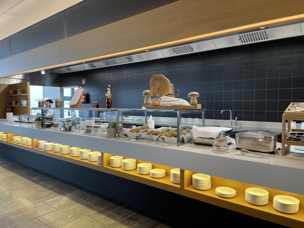 a kitchen with a counter top and shelves of food