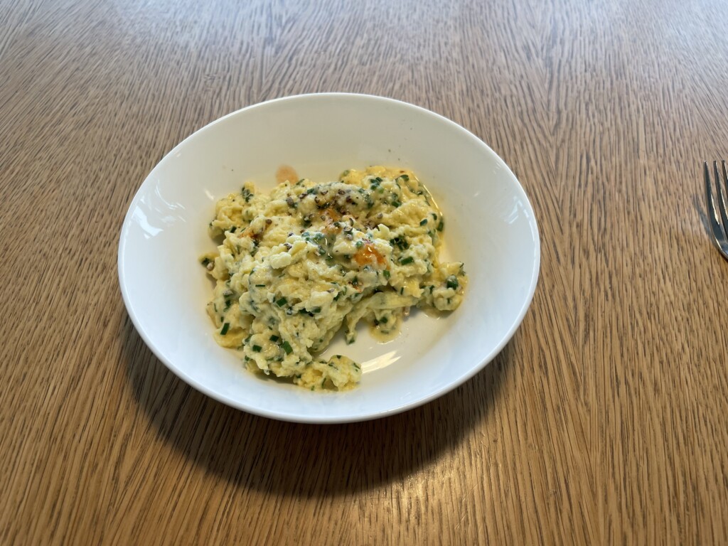 a plate of scrambled eggs on a table