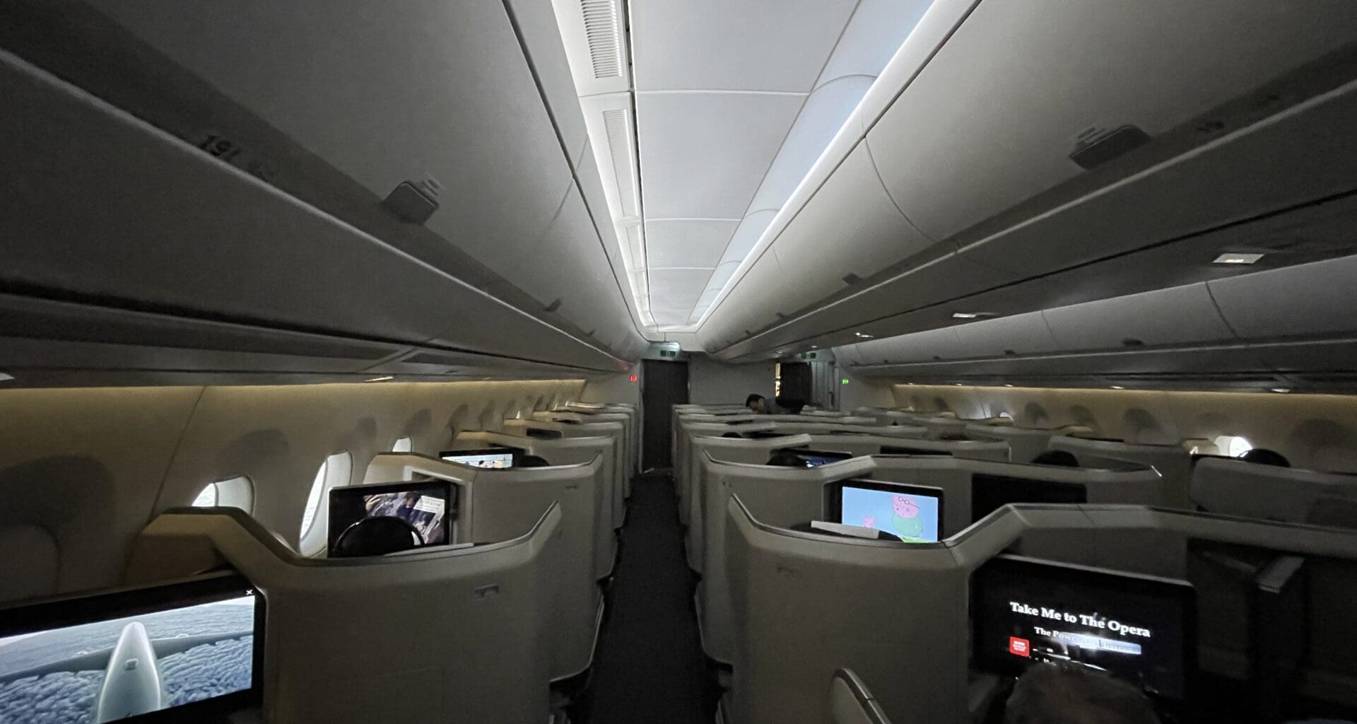 a row of seats with monitors on the back