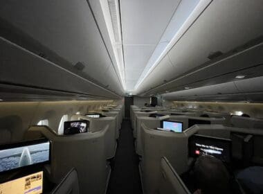 a row of seats with monitors on the back