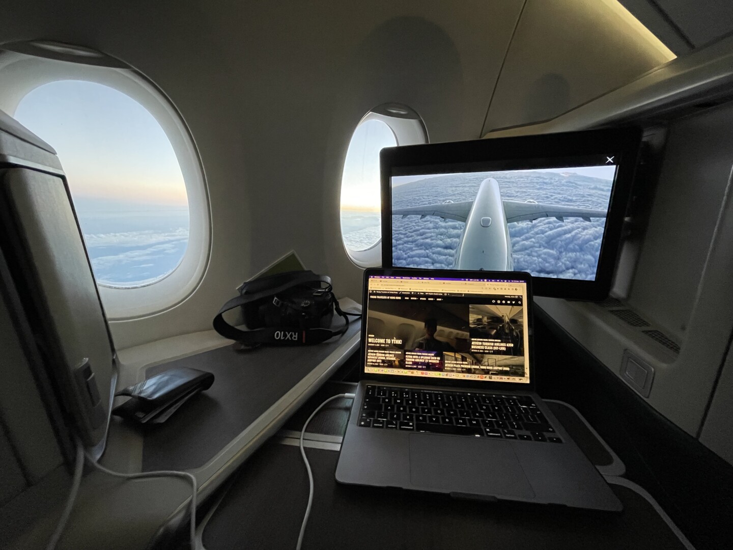 a laptop on a desk in an airplane