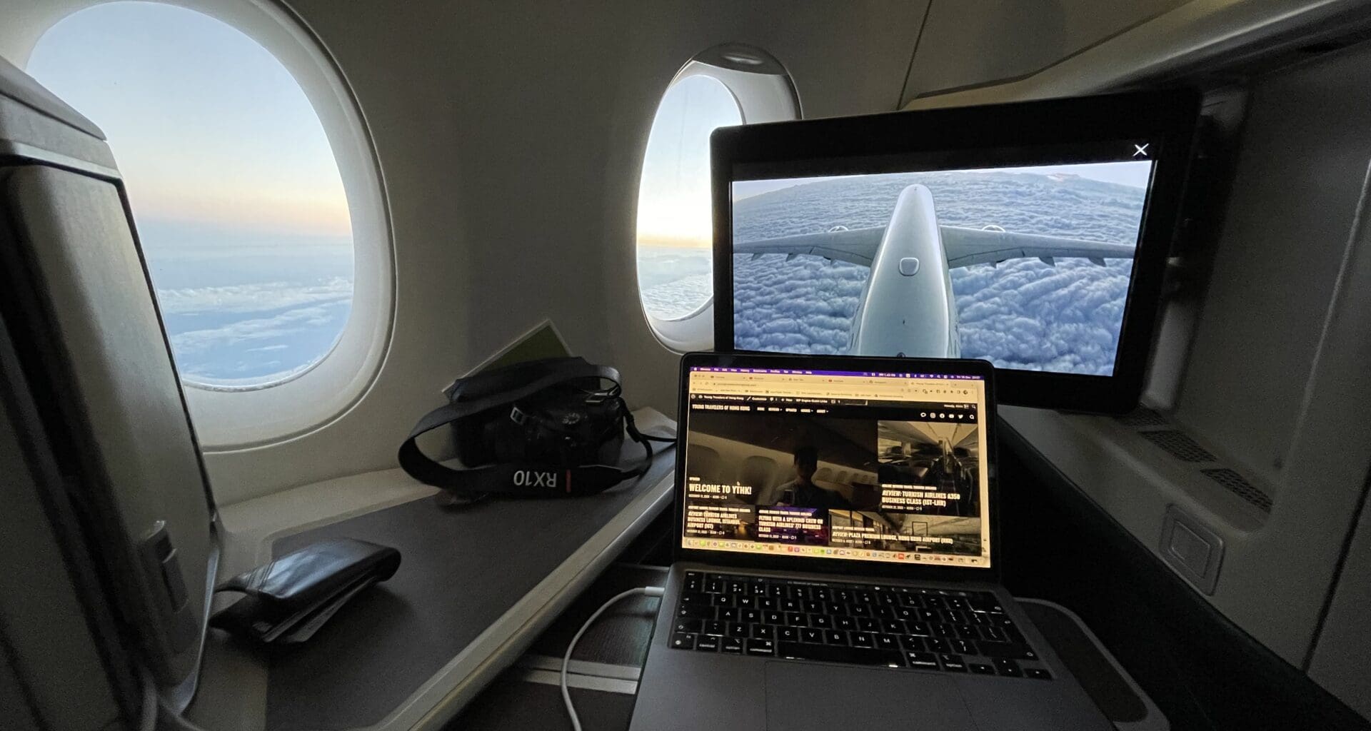 a laptop on a desk in an airplane