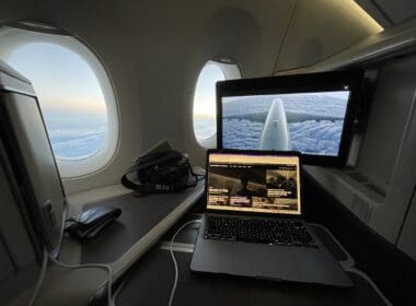a laptop on a desk in an airplane