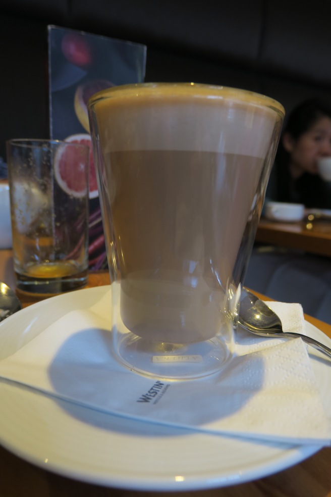 a glass of coffee on a plate