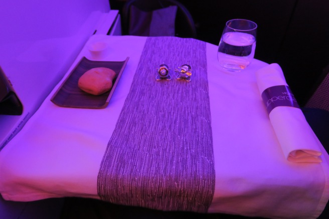 a table with a plate of food and glasses on it