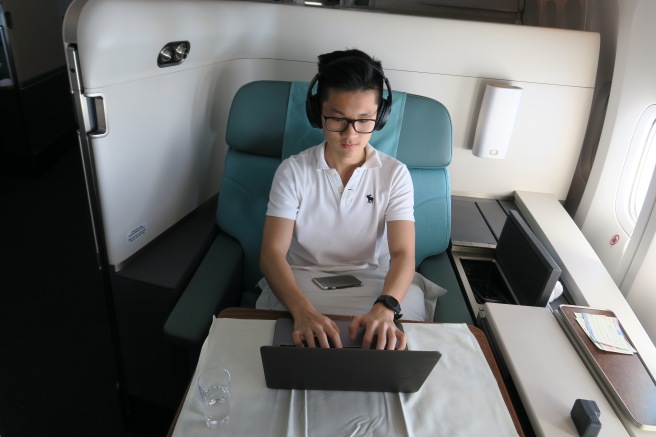 a man sitting in a chair using a laptop