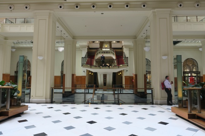 a large white building with black and white tile floor