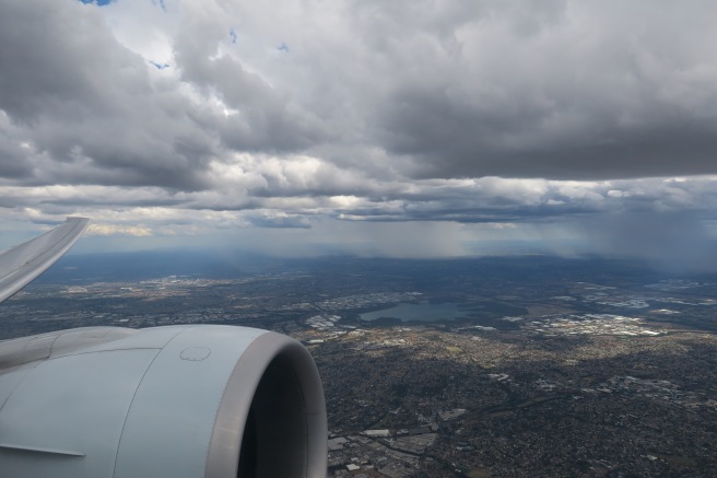 an airplane wing and a city