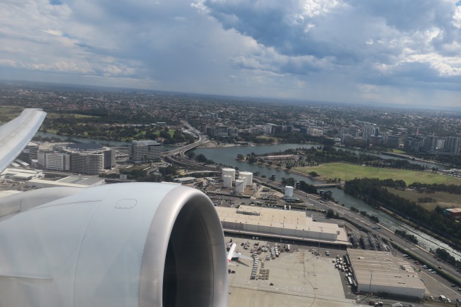 an airplane wing with a city and water