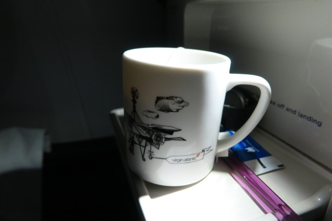 a white mug with a drawing on it