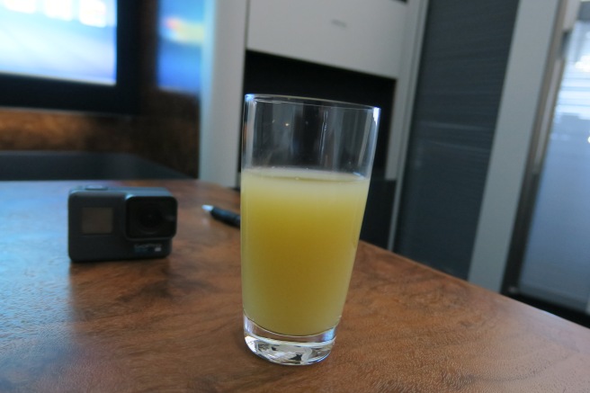 a glass of orange juice on a table