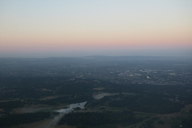 a landscape with a city and a river