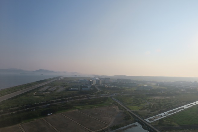 a landscape with a body of water and buildings