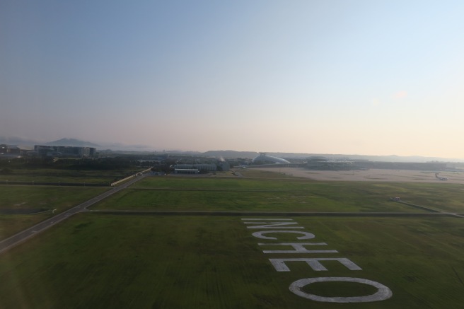 a green field with white letters painted on it