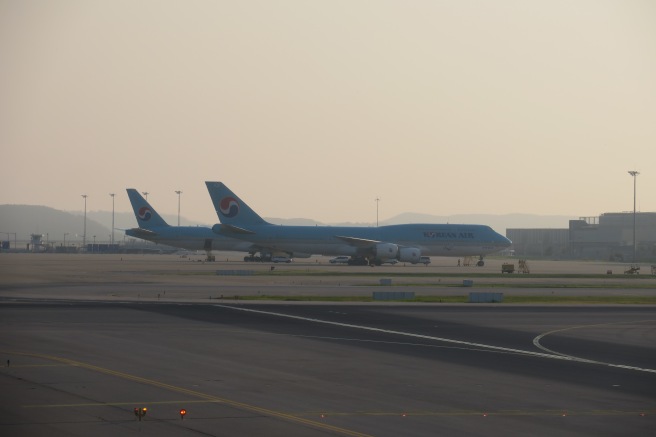 a group of airplanes on a runway