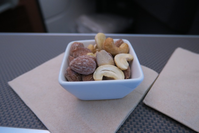 a bowl of nuts on a napkin