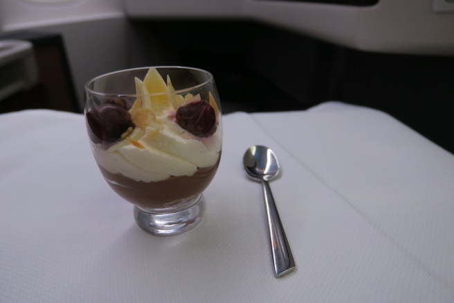 a dessert in a glass with a spoon