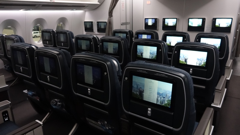 a row of seats with monitors on them