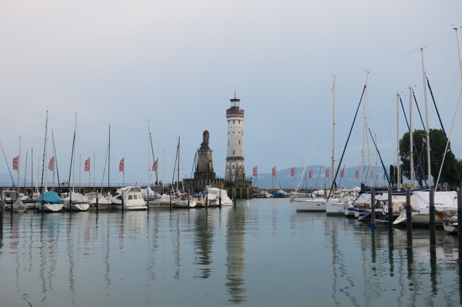 a harbor with many boats and a lighthouse