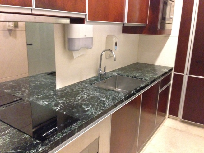 a kitchen with a sink and a mirror