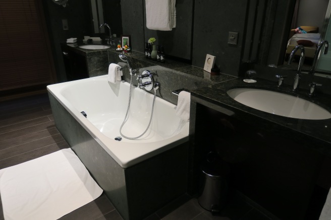 a bathroom with a tub and sink