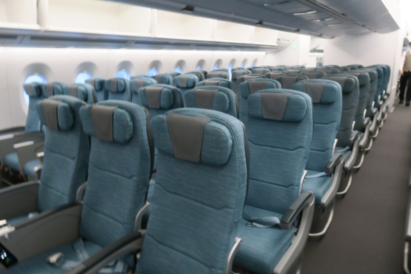 a row of blue seats in an airplane