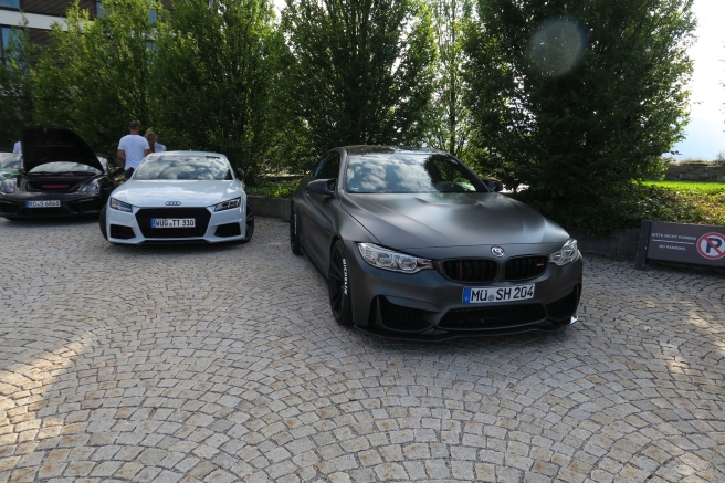 two cars parked on a brick road