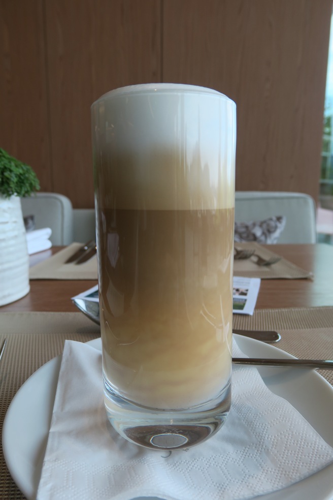 a glass of coffee on a plate