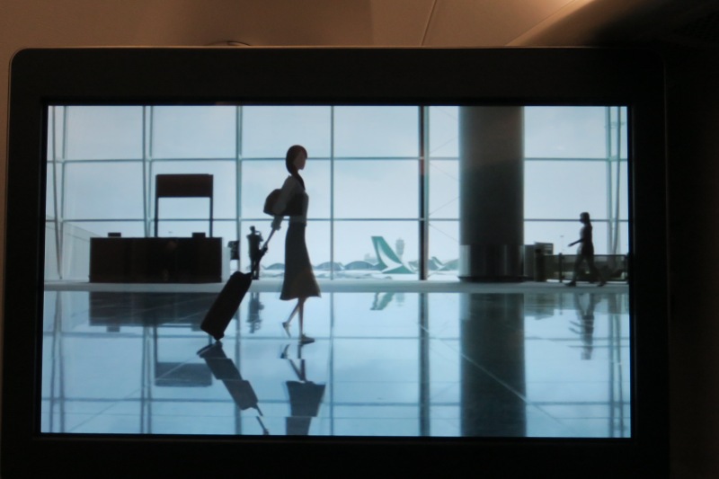 a woman walking with luggage in an airport