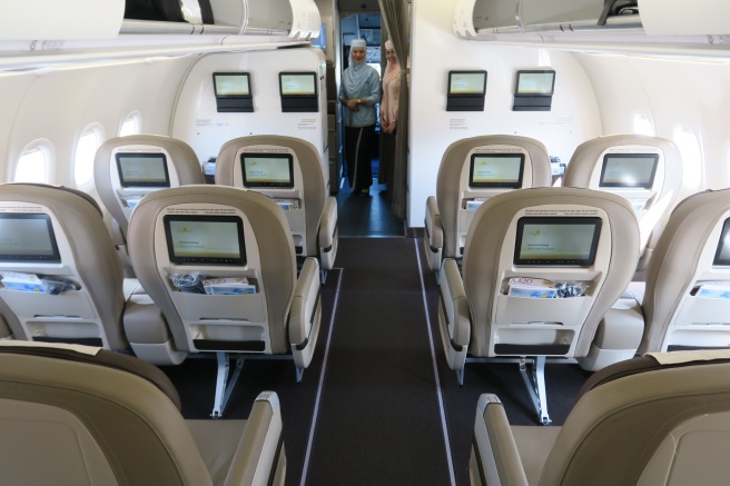 a group of people standing in an airplane