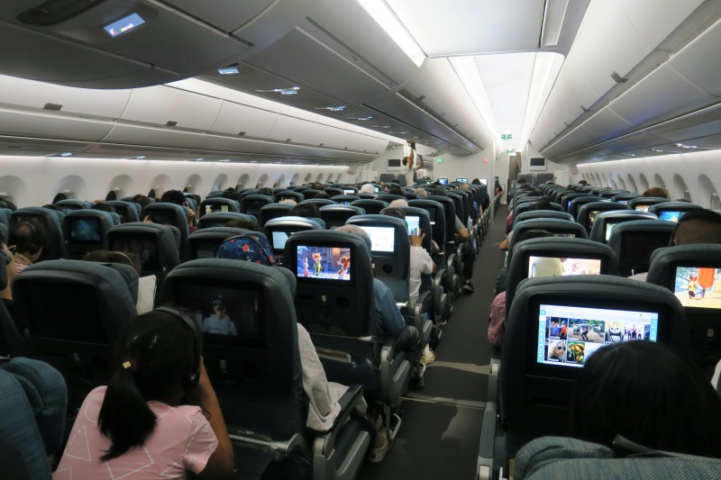 a group of people sitting in an airplane