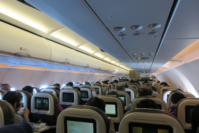 a group of people sitting in an airplane