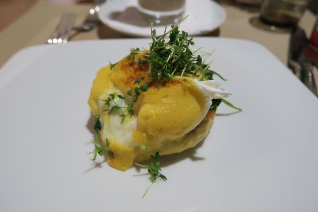 a plate of food with sprouts on top