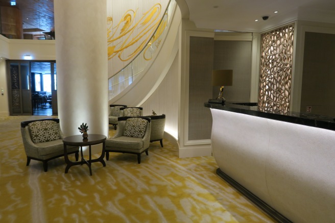 a lobby with a reception desk and chairs