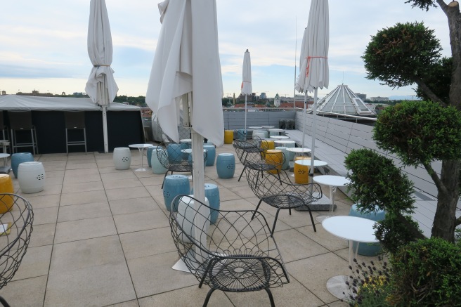 a patio with chairs and umbrellas