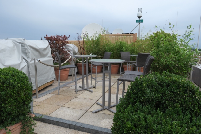 a patio with chairs and tables