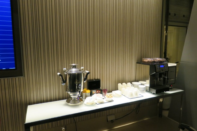 a coffee machine and cups on a table