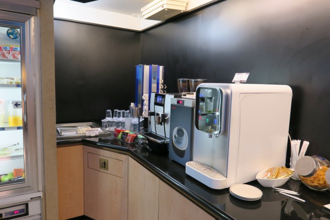 a coffee machine and coffee maker on a counter