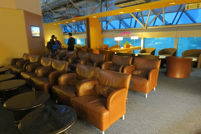 a room with brown leather chairs and tables